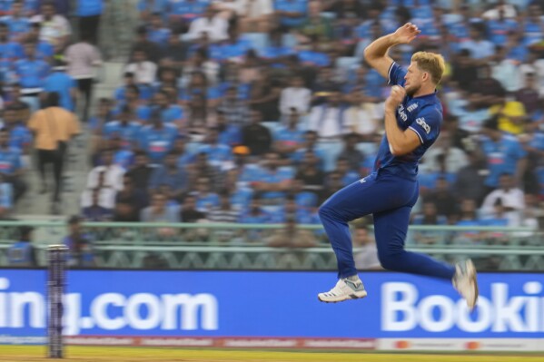 England's David Willey bowls a delivery during the ICC Men's Cricket World Cup match between India and England in Lucknow, India, Sunday, Oct. 29, 2023. (AP Photo/Manish Swarup)