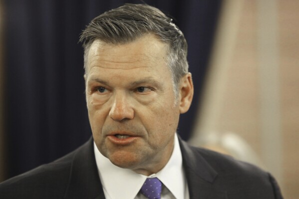 Kansas Attorney General Kris Kobach answers questions during a news conference about a new state law that defines male and female in state law so that transgender people can't change their driver's licenses and birth certificates to reflect their gender identities, Monday, June 26, 2023, at the Statehouse in Topeka, Kansas. The number of people making those changes jumped more than 300% this year ahead of the new law taking effect. (AP Photo/John Hanna)