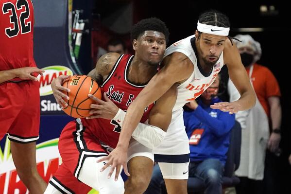 St. Francis' Ronell Giles Jr., left, is pressured by Illinois' Jacob Grandison during the first half of an NCAA college basketball game Saturday, Dec. 18, 2021, in Champaign, Ill. (AP Photo/Charles Rex Arbogast)