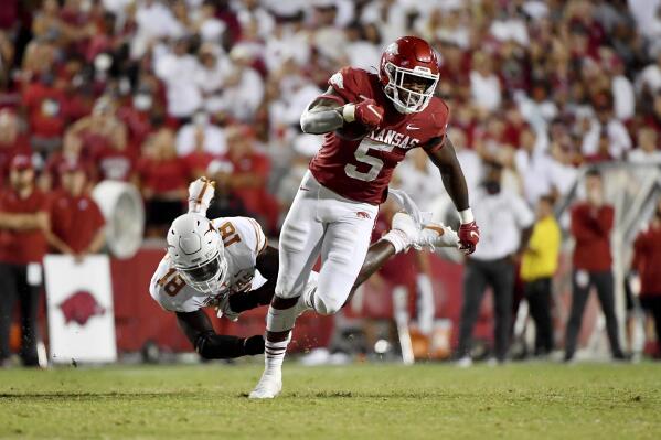Arkansas running back Raheim Sanders (5) sheds Texas defender Ovie Oghoufo (18) as he runs for a touchdown during the second half of an NCAA college football game Saturday, Sept. 11, 2021, in Fayetteville, Ark. (AP Photo/Michael Woods)