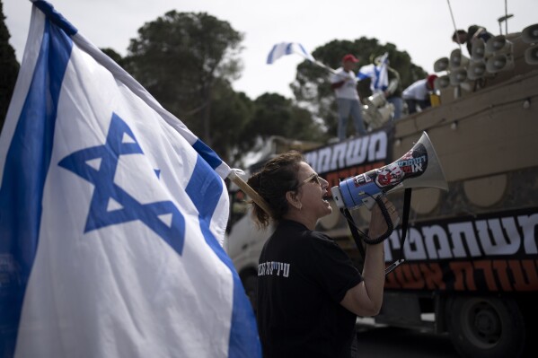 Members of Brothers and Sisters in Arms and Bonot Alternativa (Women Building an Alternative) protest Israel's exemptions for ultra-Orthodox Jews from mandatory military service, near the Prime Minister's office in Jerusalem, Tuesday, March 26, 2024. (AP Photo/Maya Alleruzzo)