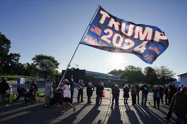 FILE - Supporters wait to enter a former President Donald Trump commit to caucus rally, Saturday, Oct. 7, 2023, in Waterloo, Iowa. By the time he returns Monday, Oct. 16, to Iowa, Trump will have drawn more than 10,000 people to his events here in less than a month. There's no guarantee his crowds will translate to support in the state's Jan. 15 caucuses that will launch the 2024 nominating cycle. But unlike his campaign in 2016, Trump has a more sophisticated organization to capitalize on his high-wattage events. (AP Photo/Charlie Neibergall, File)