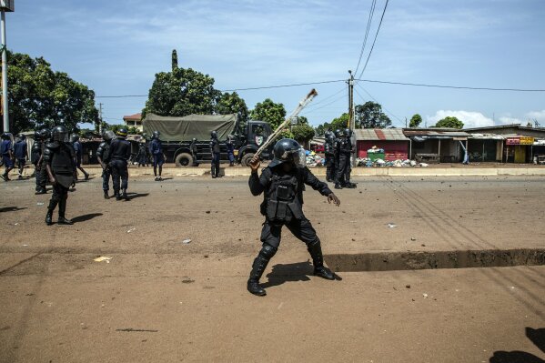 Police engage supporters of Guinean opposition leader Cellou Dalein Diallo demonstrating in Conakry, Guinea, Wednesday, Oct. 21, 2020. Diallo declared himself winner against incumbent President Alpha Conde in Sunday's presidential elections.(AP Photo/Sadak Souici)