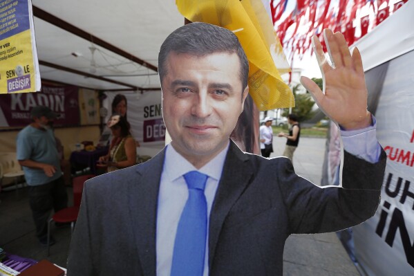 A cardboard cut-out of Selahattin Demirtas is pictured at an election kiosk in Istanbul, June 20, 2018. (AP Photo/Lefteris Pitarakis, File)