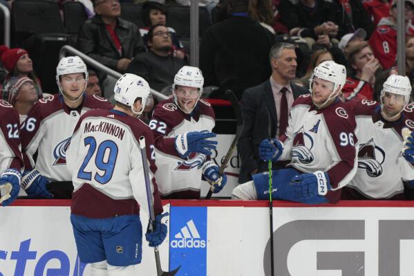 Colorado Avalanche center Nathan MacKinnon (29) is congratulated by teammates after scoring a goal against the Washington Capitals during the second period of an NHL hockey game Saturday, Nov. 19, 2022, in Washington. (AP Photo/Jess Rapfogel)