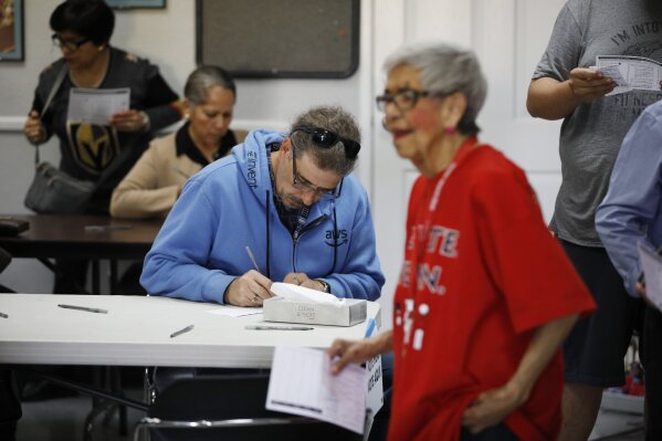 People fill out ballots to vote early at the Culinary Workers union Monday, Feb. 17, 2020, in Las Vegas. (AP Photo/John Locher)