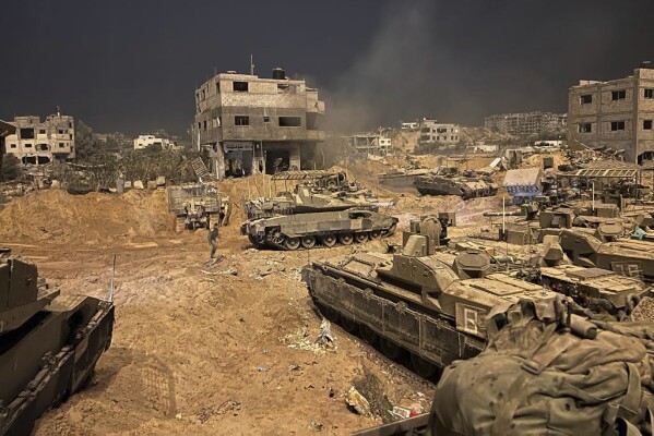 In this undated photo provided by the Israeli military, Israeli armored personnel carriers are seen during a ground operation in the Gaza Strip. Israeli ground forces have been operating in Gaza in recent days as Israel presses ahead with its war against Hamas militants. (Israel Defense Forces via AP)