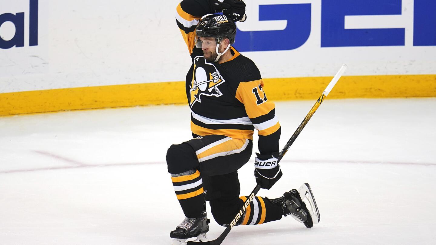 Pittsburgh Penguins' Bryan Rust (17) celebrates his goal with Sidney Crosby  during the first period of an NHL hockey game against the Boston Bruins in  Pittsburgh, Saturday, April 1, 2023. (AP Photo/Gene