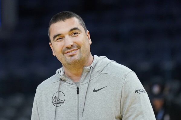 Golden State Warriors assistant coach Dejan Milojevic smiles before an NBA preseason basketball game against the Denver Nuggets in San Francisco, Friday, Oct. 14, 2022. Warriors assistant coach Dejan Milojević, a mentor to two-time NBA MVP Nikola Jokic and a former star player in his native Serbia, died Wednesday, Jan. 17, 2024, after suffering a heart attack, the team announced. Milojević, part of the staff that helped the Warriors win the 2022 NBA championship, was 46. (AP Photo/Jeff Chiu)