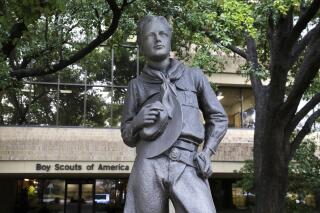 FILE - In this Feb. 12, 2020, file photo, a statue stands outside the Boy Scouts of America headquarters in Irving, Texas. One of the primary insurers of the Boy Scouts of America announced Tuesday, Sept. 14, 2021, that it has reached a tentative settlement agreement with the organization and with attorneys representing tens of thousands of men who say they were molested as youngsters decades ago by scoutmasters and others. (AP Photo/LM Otero, File)