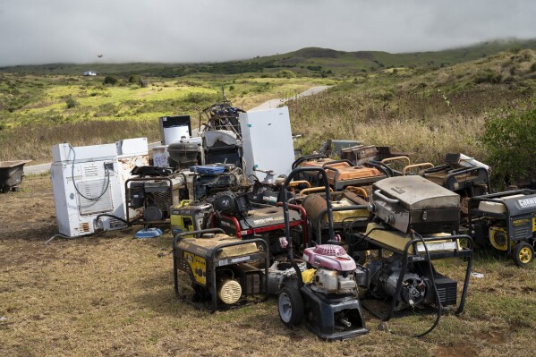 Unused refrigerators and generators are temporarily stored at Kahikinui homestead on Sunday, July 7, 2024, in Kahikinui, Hawaii. Residents were asked to remove unused items to reduce fire risks. (AP Photo/Mengshin Lin)