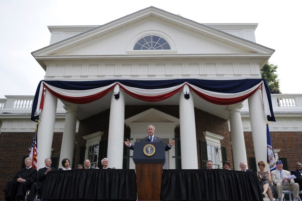 FILE - President George W. Bush gestures during remarks at Monticello's 46th annual Independence Day celebration and naturalization ceremony in Charlottesville, Va., July 4, 2008. (AP Photo/Evan Vucci, File)