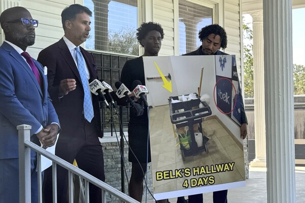 Attorneys Chris Hart, left, and Seth Rose, second from left, speak to announce that the family of a Belk employee is suing the department store chain after a worker died in a bathroom and was not found for four days during a news conference on Tuesday, Sept. 19, 2023, in Columbia, S.C. Investigator said Bessie Durham's cleaning cart was outside the locked bathroom door the whole time. (AP Photo/Jeffrey Collins)