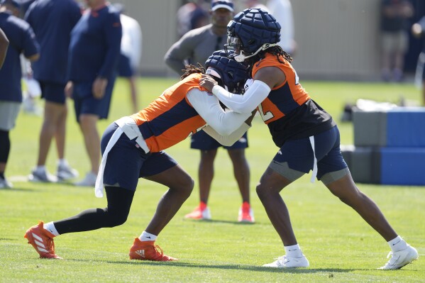 Denver Broncos linebacker Randy Gregory, left, squares off against linebacker Nik Bonitto during an NFL football training camp at the team's headquarters Friday, July 28, 2023, in Centennial, Colo. (AP Photo/David Zalubowski)