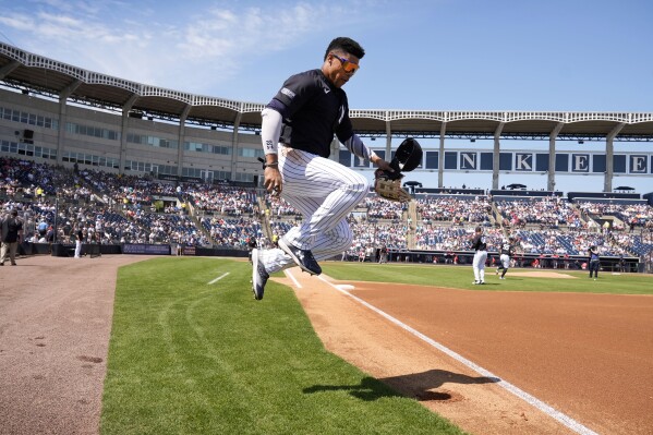 New York Yankees right fielder Juan Soto leaps to the field during the first inning of a spring training baseball game against the Boston Red Sox Wednesday, March 13, 2024, in Tampa, Fla. (AP Photo/Charlie Neibergall)