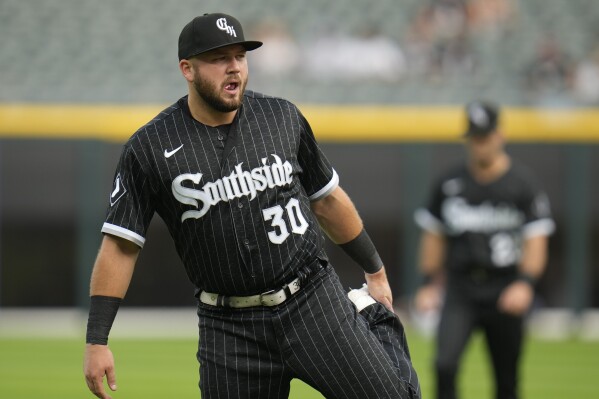 Chicago White Sox's Jake Burger warms up before a baseball game against the Cleveland Guardians, Friday, July 28, 2023, in Chicago. (AP Photo/Erin Hooley)