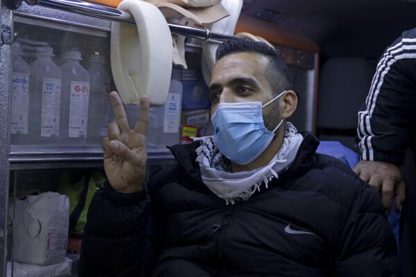 Former Palestinian prisoner Khaled Fasfous makes a victory sign in an ambulance after praying at the tomb of Palestinian leader Yasser Arafat, in the West Bank city of Ramallah, Sunday, Dec. 5, 2021. Israel released Fasfous, two weeks after striking a deal that ended his marathon 131-day hunger strike. Fasfous was the symbolic figurehead of six hunger strikers protesting Israel’s controversial policy of “administrative detention” that allows suspects to be held indefinitely without charge for months and even years (AP Photo/Majdi Mohammed)