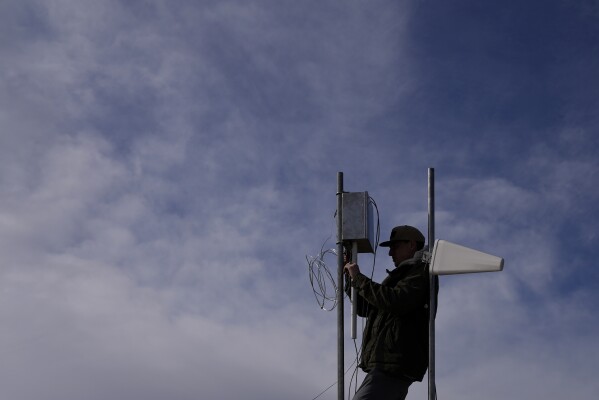 FILE - Carver Cammans installs cloud seeding equipment Saturday, Dec. 3, 2022, in Lyons, Colo. With cloud seeding, it may rain, but it doesn’t really pour or flood. (AP Photo/Brittany Peterson, File)