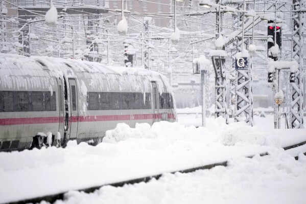 A train is parked at the central station after heavy snow fall in Munich, Germany, Saturday, Dec. 2, 2023. (AP Photo/Matthias Schrader)