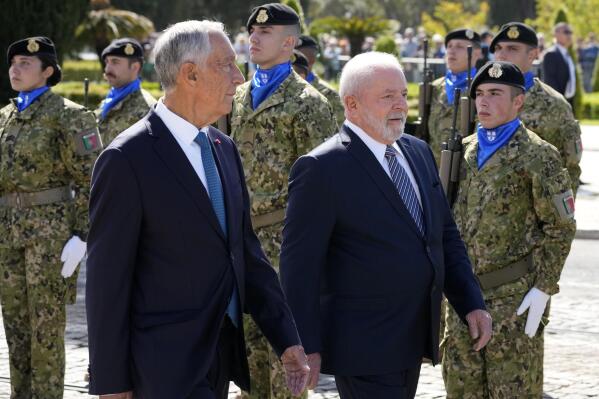 Brazilian President Luis Inacio Lula da Silva and Portuguese President Marcelo Rebelo de Sousa reviewing the troops during welcome ceremony outside the 16th century Jeronimos monastery in Lisbon, Saturday, April 22, 2023. Lula da Silva is in Lisbon for a four day state visit to Portugal. (AP Photo/Armando Franca)