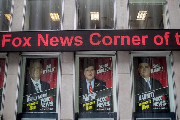 FILE - Posters of Fox News Channel personalities are displayed at the News Corp. headquarters in New York, April 19, 2017. Oregon's attorney general announced Monday, June 5, 2023, she has begun investigating the board of directors of Fox Corp., for breaching its fiduciary duties by allowing Fox News to broadcast false claims about the 2020 presidential election, claims that cost the broadcaster almost $800 million in a lawsuit. (AP Photo/Mary Altaffer, File)