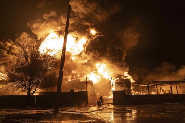 FILE - Firefighters extinguish a fire after a Russian attack on a residential neighborhood in Kharkiv, Ukraine Feb. 10, 2024. A new poll from The Associated Press-NORC Center for Public Affairs Research finds that U.S. adults have become fractured along party lines in their support for military aid for Ukraine. (AP Photo/Yevhen Titov, File)