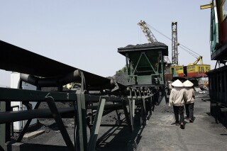 FILE - Workers are seen in Ninh Binh Power Plant, which is a coal fired power plant to supply electricity, in Ninh Binh Province in Vietnam, on Sept. 19, 2007. A plan for how Vietnam will spend $15.5 billion to transition to cleaner energy has been finalized and will be announced at the COP28 climate conference, which begins in Dubai next week. (AP Photo/Chitose Suzuki, File)