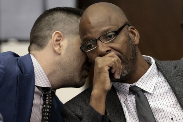 FILE - Christopher Dunn, right, listens to his attorney Justin Bonus from New York City during the first day of his hearing to decide whether to vacate his murder conviction, Tuesday, May 21, 2024, at the Carnahan Courthouse in St. Louis. A Missouri judge on Monday, July 24, 2024, overturned the conviction of Dunn, who has spent more than 30 years in prison for a killing he has long contended he didn’t commit. (Laurie Skrivan/St. Louis Post-Dispatch via AP, Pool, File)