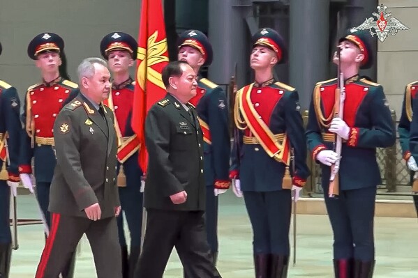 In this photo released by Russian Defense Ministry Press Service, Gen. Zhang Youxia, vice chairman of China's Central Military Commission, center, and Russian Defense Minister Sergei Shoigu, left, attend an official welcome ceremony prior to their talks in Moscow, Russia, Wednesday, Nov. 8, 2023. (Russian Defense Ministry Press Service via AP)