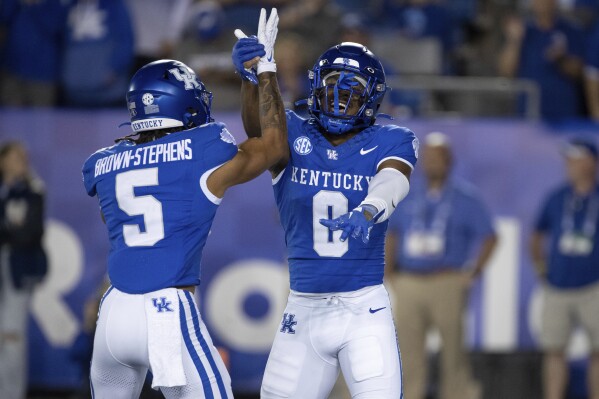 Kentucky wide receiver Anthony Brown-Stephens (5) and running back Demie Sumo-Karngbaye (0) celebrate in the end zone after a touchdown during the second half of an NCAA college football game against Akron in Lexington, Ky., Saturday, Sept. 16, 2023. (AP Photo/Michelle Haas Hutchins)