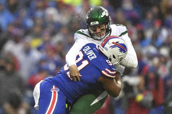 Buffalo Bills defensive tackle Ed Oliver (91) collides with New York Jets quarterback Mike White (5) during the first half of an NFL football game, Sunday, Dec. 11, 2022, in Orchard Park, N.Y. (AP Photo/Adrian Kraus)