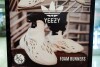 FILE - A sign advertises Yeezy shoes made by Adidas at Kickclusive, a sneaker resale store, in Paramus, N.J., Oct. 25, 2022. Shoe and sports clothing maker Adidas said Monday, Feb. 26, 2024, it had started a third sale of the Yeezy sneakers it was left with after severing ties with Ye, the rapper formerly known as Kanye West.(AP Photo/Seth Wenig, File)