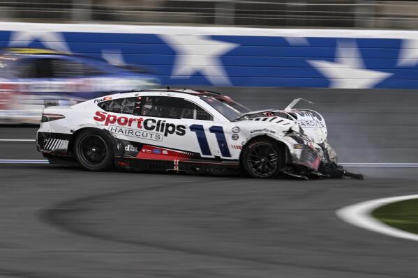 Denny Hamlin (11) crashes on the front stretch during a NASCAR Cup Series auto race at Charlotte Motor Speedway, Monday, May 29, 2023, in Concord, N.C. (AP Photo/Matt Kelley)