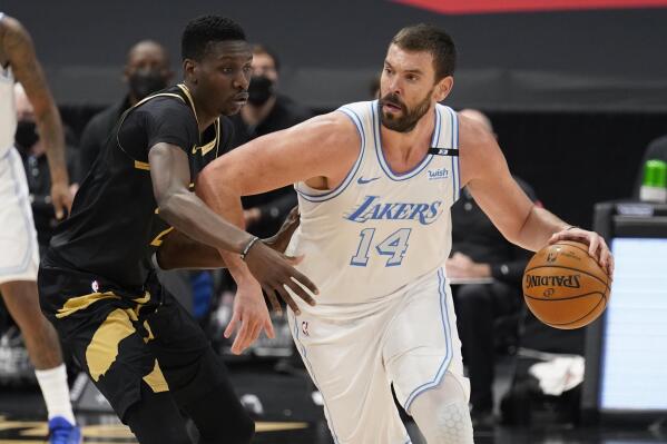 FILE - In this April 6, 2021, file photo, Los Angeles Lakers center Marc Gasol (14) drives as Toronto Raptors forward Chris Boucher (25) defends during an NBA basketball game in Tampa, Fla. The Lakers have traded the rights to Gasol back to the Memphis Grizzlies, where the 36-year-old center spent his first 11 NBA seasons. The Lakers also sent a second-round pick in 2024 and cash to Memphis on Friday, Sept. 10, in exchange for the draft rights to Chinese big man Wang Zhelin. (AP Photo/Chris O'Meara, File)