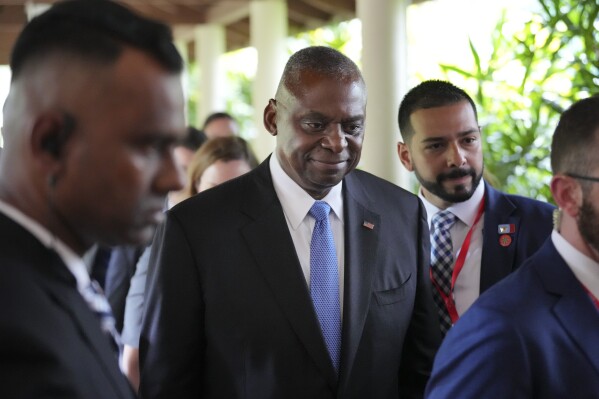 U.S. Secretary of Defence Lloyd Austin, center, walks out after a bilateral meeting with China's Defence Minister Dong Jun on the sidelines of the 21st Shangri-La Dialogue summit at the Shangri-La Hotel in Singapore Friday, May 31, 2024. (AP Photo/Vincent Thian)