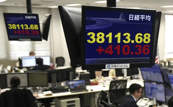 Monitors show Nikkei stock index, yellow, at a foreign exchange trader's company in Tokyo, Thursday, Feb. 15, 2024. Shares rose in Asia on Thursday after Wall Street stocks recovered much of their sharp losses from a day before.(Kyodo News via AP)