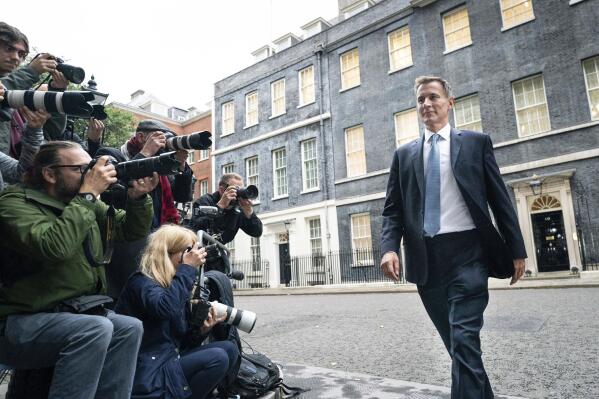 Jeremy Hunt leaves 10 Downing Street in London after he was appointed Chancellor of the Exchequer following the resignation of Kwasi Kwarteng, Friday Oct. 14, 2022. Chancellor of the Exchequer Kwasi Kwarteng said he has accepted Prime Minister Liz Truss' request he "stand aside" as Chancellor, paying the price for the chaos unleashed by his mini-budget. (Stefan Rousseau/PA via AP)