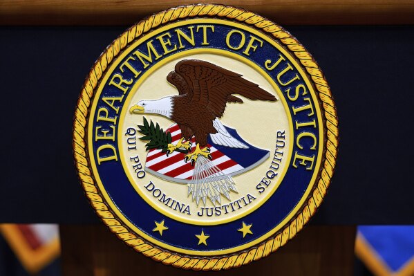 The U.S. Department of Justice logo is seen on a podium before a press conference with Attorney General Pam Bondi, Tuesday, May 6, 2025, at the Justice Department in Washington. (AP Photo/Julia Demaree Nikhinson, file)