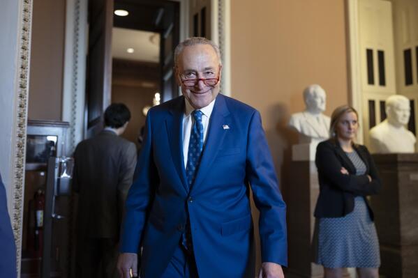 Senate Majority Leader Chuck Schumer, D-N.Y., grins as he emerges from the closed-door Senate Democratic Caucus leadership election at the Capitol in Washington, Thursday, Dec. 8, 2022. Sen. Schumer will remain as Senate Democratic leader and chair of the Democratic Conference in the new Congress beginning Jan. 3, 2023. (AP Photo/J. Scott Applewhite)