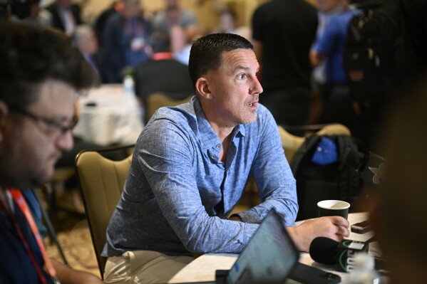 New Orleans Saints head football coach Dennis Allen, center, talks with reporters during an NFC coaches availability at the NFL football owners meetings, Tuesday, March 26, 2024, in Orlando, Fla. (AP Photo/Phelan M. Ebenhack)