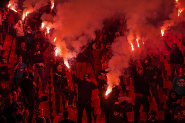 Zenit fans light fireworks during an international friendly soccer match between Red Star and Zenit St. Petersburg at the Rajko Mitic Stadium in Belgrade, Serbia, Saturday, March 23, 2024. (AP Photo/Darko Vojinovic)