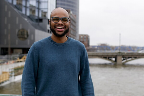 Arick Davis, owner of Last Mile Cafe, poses for a portrait outside of DeVos Place convention center during the annual State of Grand Rapids Business event on Jan. 31, 2024, in Grands Rapids, Mich. Davis says, “I will not vote for someone who could cause so much instability," but is well aware that consumers are feeling pressure on how much they can spend and the challenge that Black-owned businesses like his have with accessing lines of credit to expand. To the extent that the economy is doing well, there is little confidence that it is necessarily sustainable. He'll vote for Biden, he says, but unenthusiastically. (AP Photo/Kristen Norman)