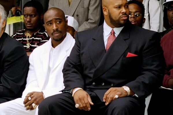FILE - Rapper Tupac Shakur, left, and Death Row Records Chairman Marion Suge Knight, attend a voter registration event in South Central Los Angeles, on Aug. 15, 1996. Shakur died on Sept. 13, 1996, the victim of a drive-by shooting in Las Vegas. Police have made an arrest for the killing of Shakur. . (AP Photo/Frank Wiese/File)