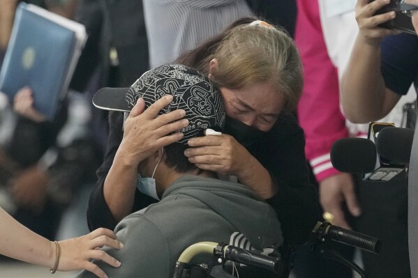 FILE - A relative hugs a Thai overseas worker who was evacuated from Israel, as he and others arrived at Suvarnabhumi International Airport in Samut Prakarn Province, Thailand, on Oct. 12, 2023. Since Hamas attacks on Israel nearly a month ago, more than 7,000 of some 30,000 Thais working in Israel have returned home on government evacuation flights. Some were abducted by Hamas fighters, while others are still missing, and a few dozens are confirmed dead. (AP Photo/Sakchai Lalit, File)