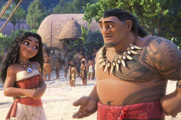 This image released by Disney shows the characters Moana, voiced by Auli'i Cravalho, left, and Chief Tui, voiced by Temuera Morrison, in a scene from "Moana 2." (Disney via AP)