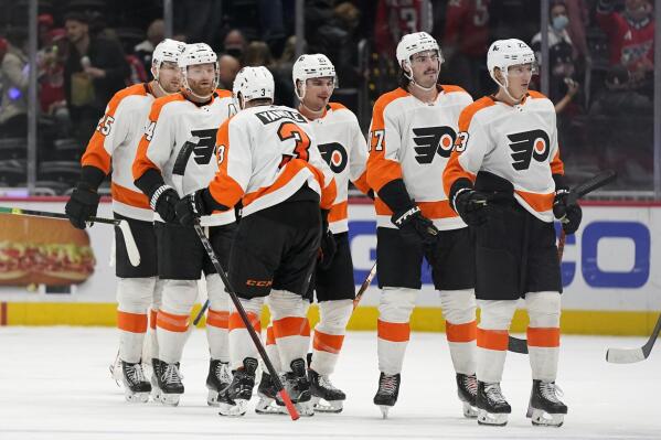 Members of the Philadelphia Flyers celebrate after an NHL hockey game against the Washington Capitals, Saturday, Nov. 6, 2021, in Washington. Philadelphia won 2-1. (AP Photo/Patrick Semansky)