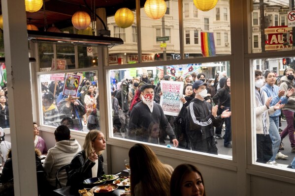 Note: obscene - US immigrants and protesters against custom enforcement raids march through San Francisco's Mission District on Monday, June 9, 2025. (AP Photo/Noah Berger)