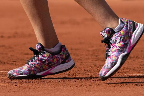United States's Sofia Kenin wearing colorful shoes plays a return to Ukraine's Elina Ostapenko during their first round match on day two of the French Open tennis tournament at Roland Garros in Paris, France, Monday, May 31, 2021. (AP Photo/Michel Euler)