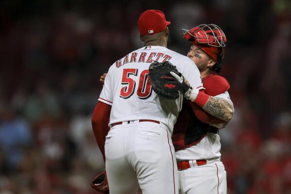 Amir Garrett leaves game with hand injury