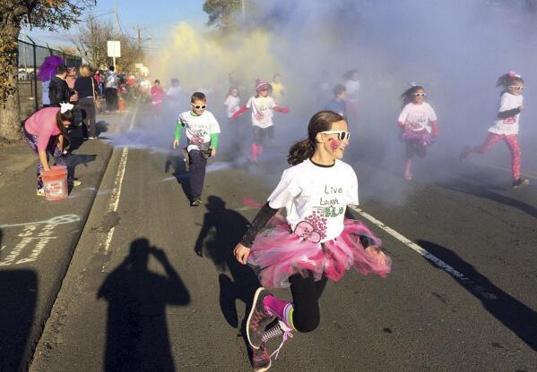 In this Nov. 5, 2016 photo, children participate in the fun run at the annual Vicki Soto 5K race in Stratford, Conn. The race is held by the Soto family to raise money to fund scholarships for students interested in careers in education. First-grade teacher Vicki Soto was one of 26 people killed during a shooting inside the Sandy Hook Elementary School on Dec. 14, 2012, in Newton, Conn. (AP Photo/Pat Eaton-Robb)